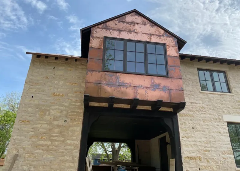 Copper metal panel facade on a stone building for Skylight Installation in Chili